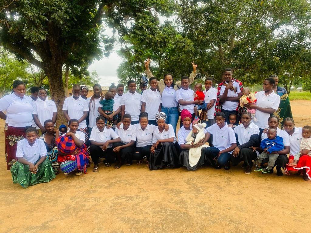 A cohort of teenage mothers and their children gathered outside a FOMO Initiative empowerment centre