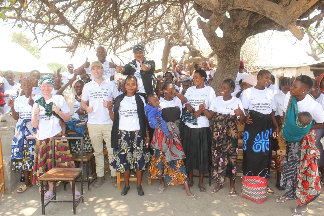 The Ivuna cohort, FOMO Initiative and Kidunda Helium representatives celebrating together under the village tree