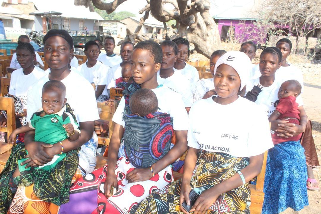 Enrolled teen mothers seated with their children at the Ivuna launch gathering
