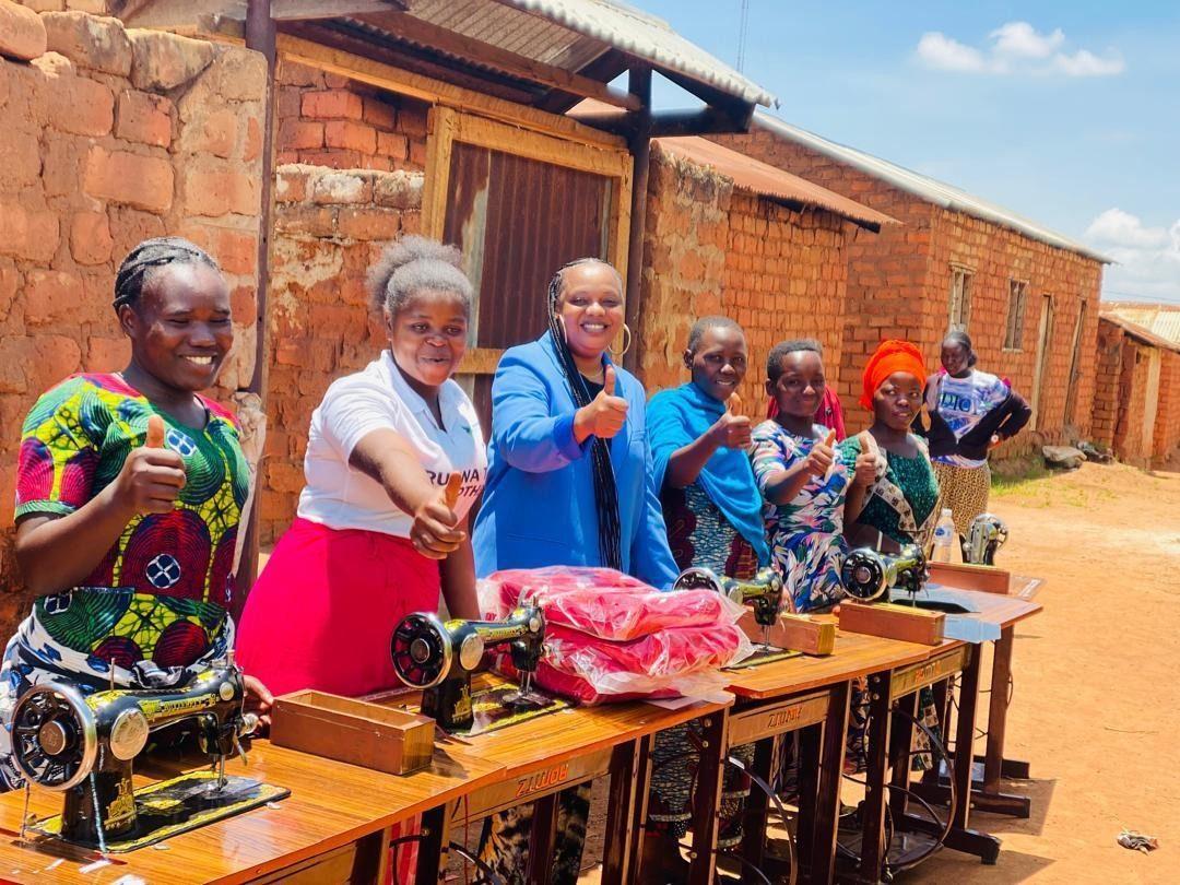 Graduates and single mothers receiving sewing machines to begin earning an income